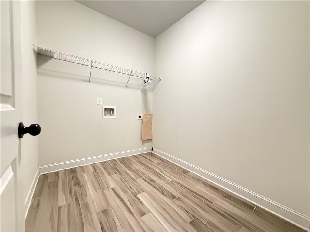 1545 Dahlia Drive Cumming, GA 30040 - Photo 21 of 50 a view of a room with wooden floor and white walls