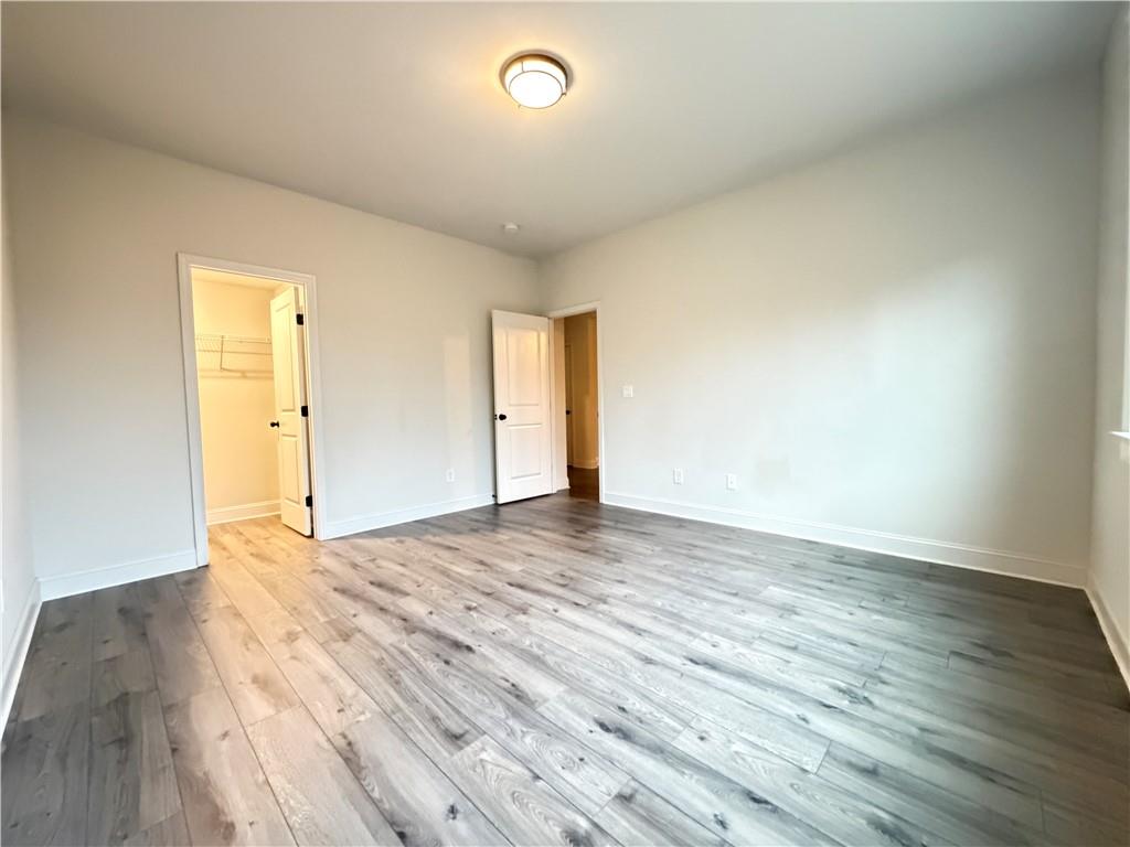 1545 Dahlia Drive Cumming, GA 30040 - Photo 23 of 50 an empty room with wooden floor and windows