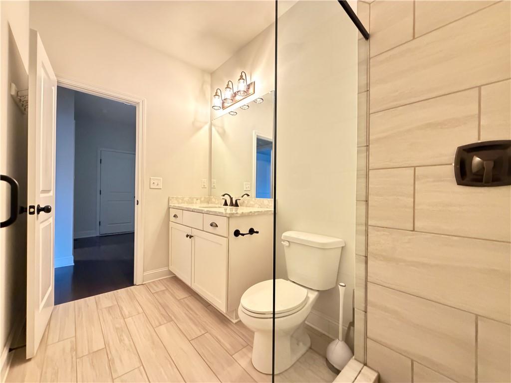 1545 Dahlia Drive Cumming, GA 30040 - Photo 25 of 50 a bathroom with a toilet sink and mirror