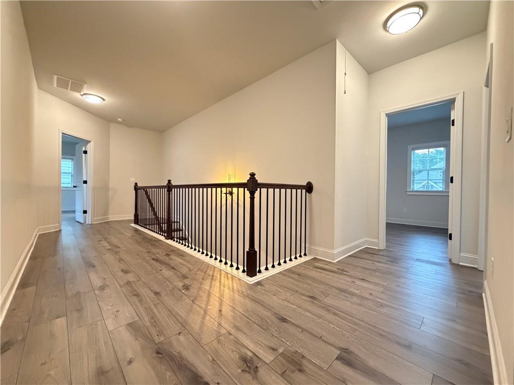 1545 Dahlia Drive Cumming, GA 30040 - Photo 27 of 50 a view of a hallway with wooden floor