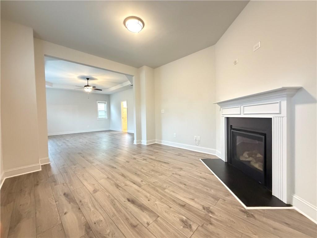1545 Dahlia Drive Cumming, GA 30040 - Photo 30 of 50 wooden floor in an empty room with a fireplace