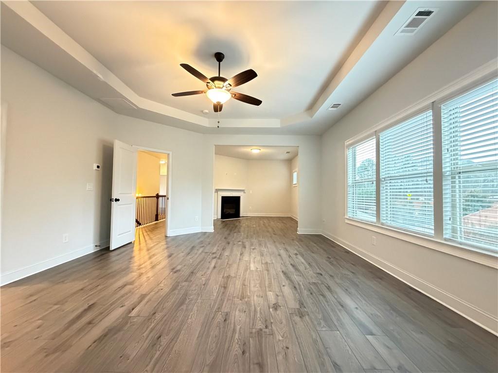 1545 Dahlia Drive Cumming, GA 30040 - Photo 31 of 50 a view of an empty room with a window and wooden floor