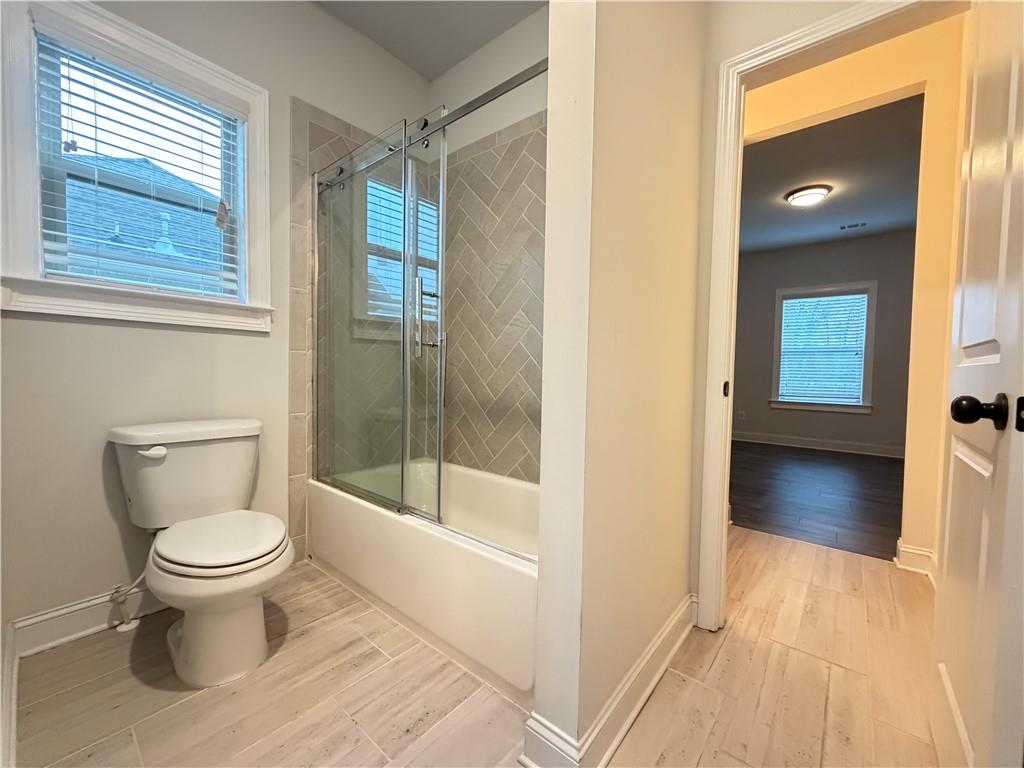 1545 Dahlia Drive Cumming, GA 30040 - Photo 39 of 50 a bathroom with a toilet and a shower