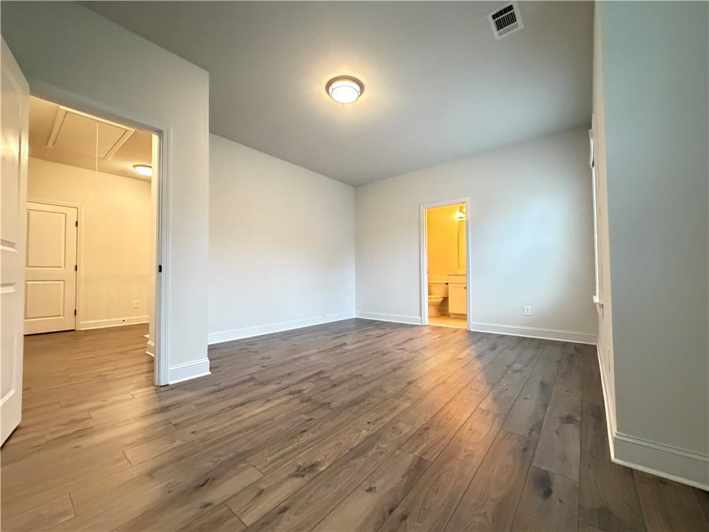 1545 Dahlia Drive Cumming, GA 30040 - Photo 44 of 50 an empty room with wooden floor and windows