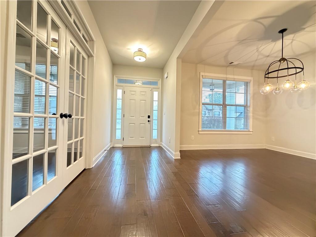 1545 Dahlia Drive Cumming, GA 30040 - Photo 6 of 50 a view of an entryway with wooden floor and windows