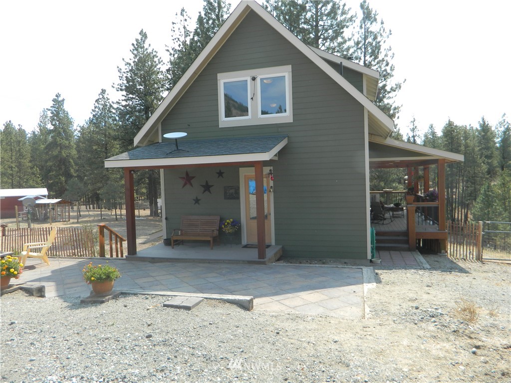 345 Neil Circle Road South Tonasket, WA 98855 - Photo 3 of 40 a front view of a house with a yard and garage