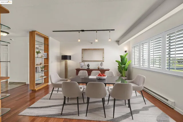 a dining room with furniture and wooden floor