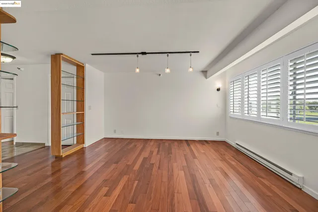 a kitchen with stainless steel appliances granite countertop a sink and a wooden floor