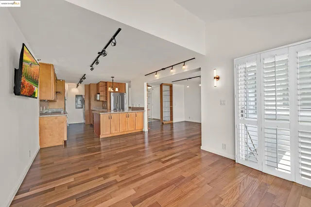 a kitchen with stainless steel appliances granite countertop a sink refrigerator stove and microwave