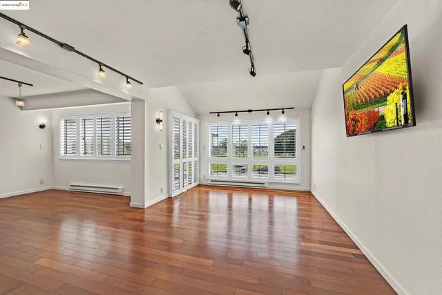 a kitchen with stainless steel appliances granite countertop a sink refrigerator and cabinets