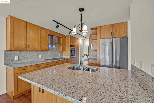 a bathroom with a granite countertop sink a toilet and mirror