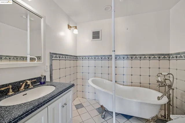 a bathroom with a granite countertop sink mirror and shower