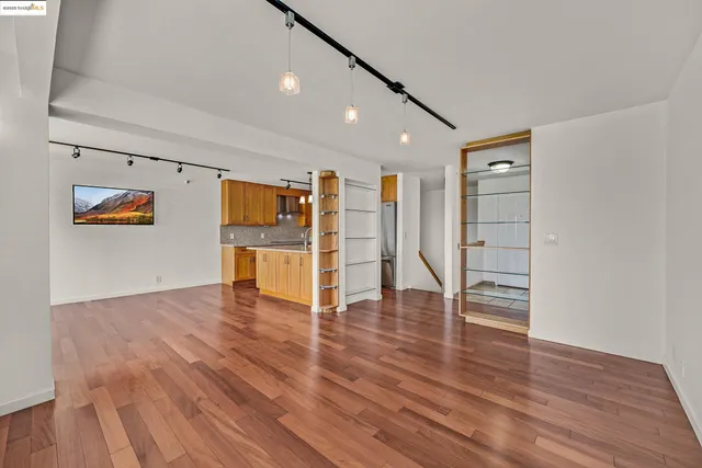 a view of a kitchen with wooden floor and a sink