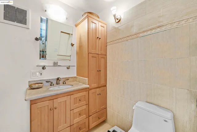 a kitchen with stainless steel appliances granite countertop a sink a stove and a wooden floors