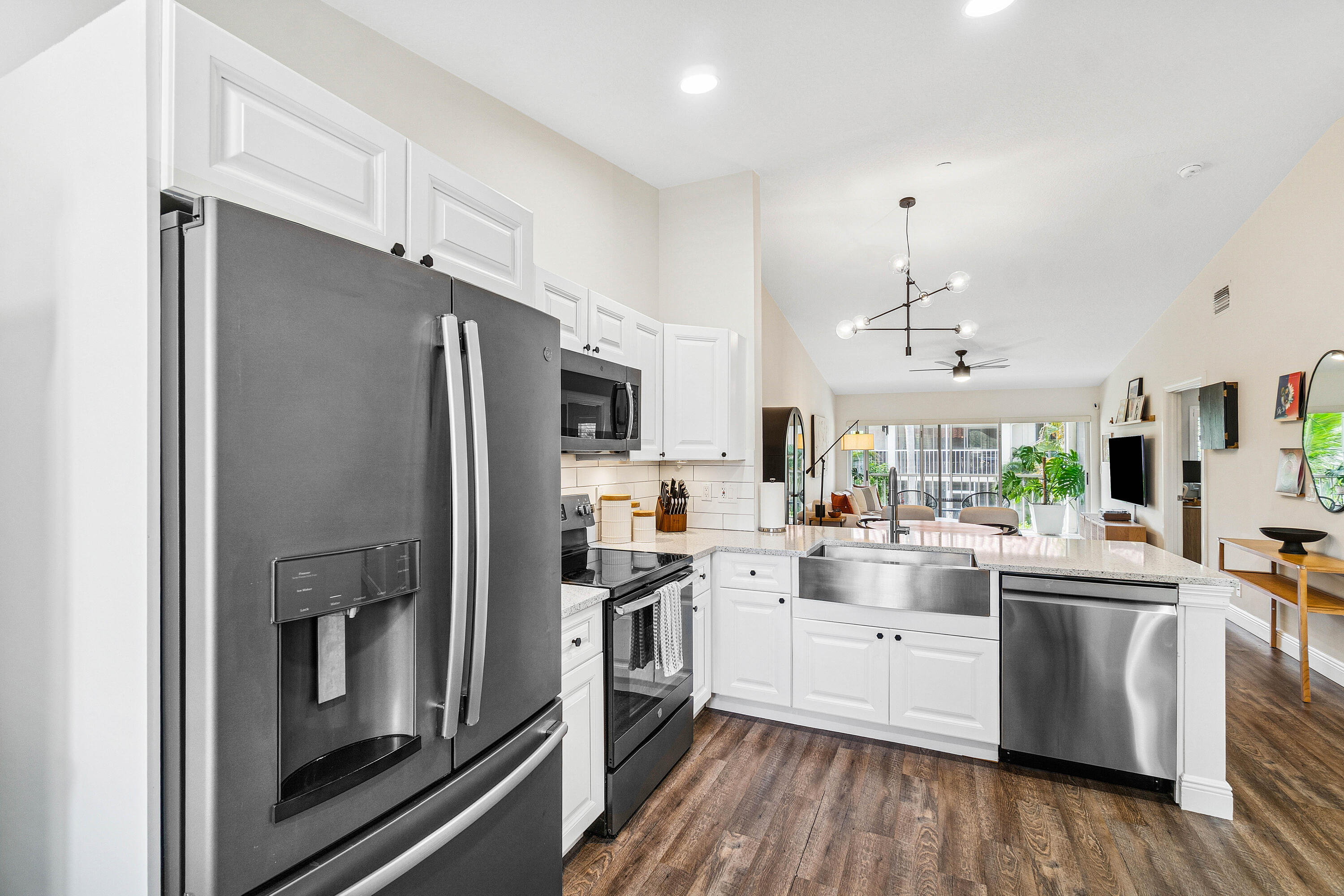 340 Northwest 67th Street, Unit 202 Boca Raton, FL 33487 - Photo 11 of 39 a kitchen with stainless steel appliances a refrigerator sink and cabinets