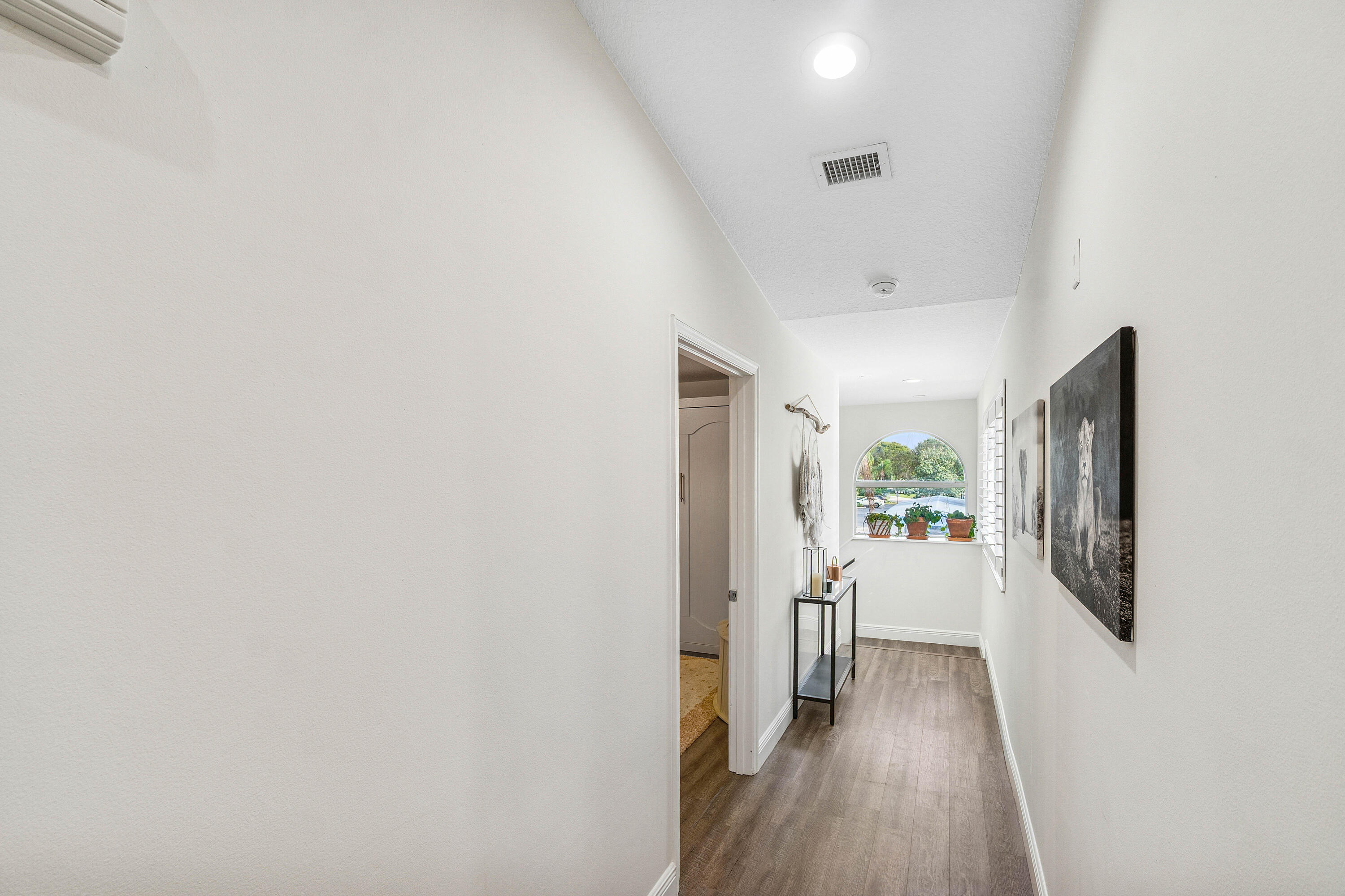 340 Northwest 67th Street, Unit 202 Boca Raton, FL 33487 - Photo 16 of 39 a view of a hallway with wooden floor and a living room