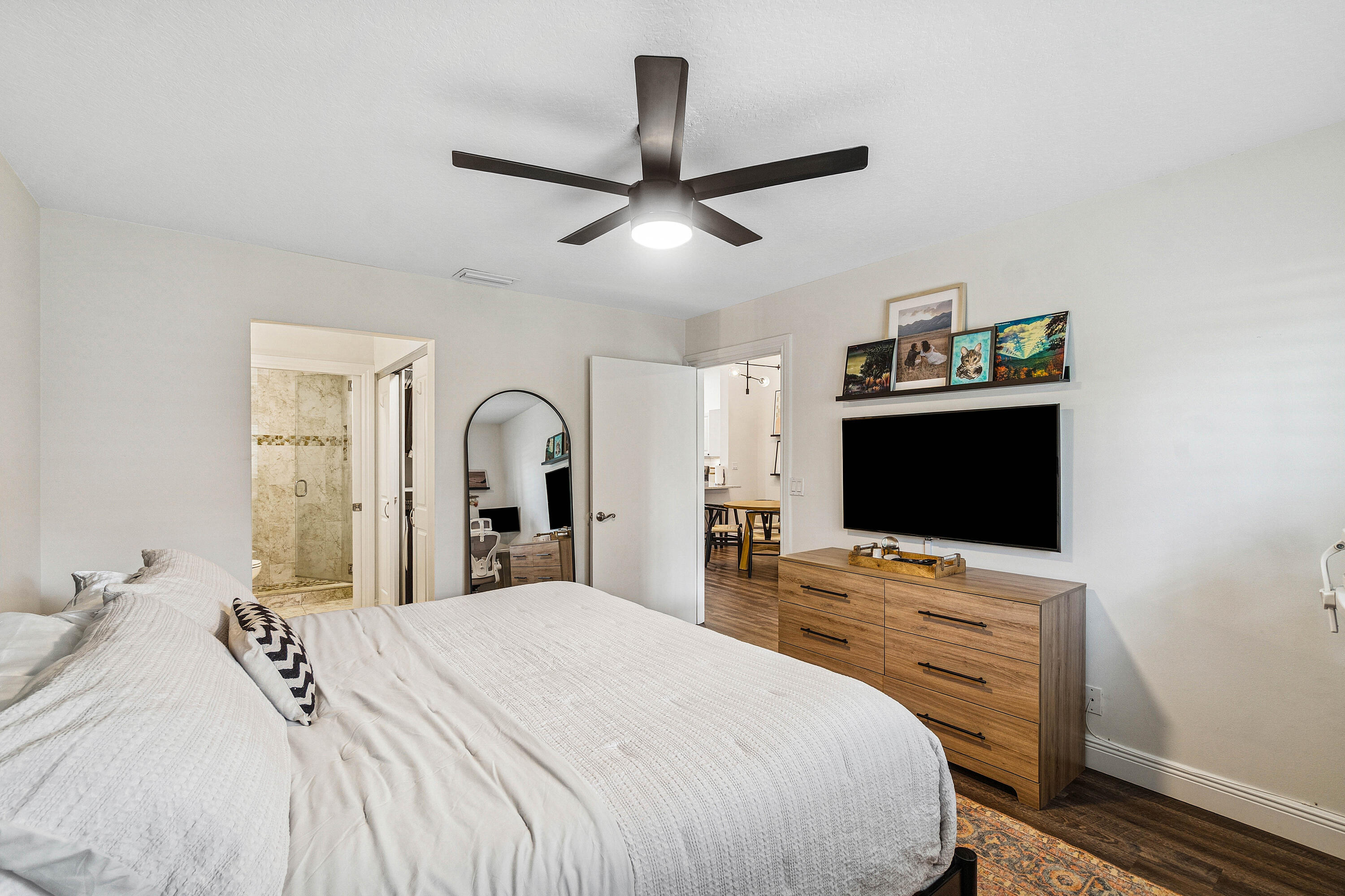 340 Northwest 67th Street, Unit 202 Boca Raton, FL 33487 - Photo 19 of 39 a bedroom with a bed and a flat screen tv