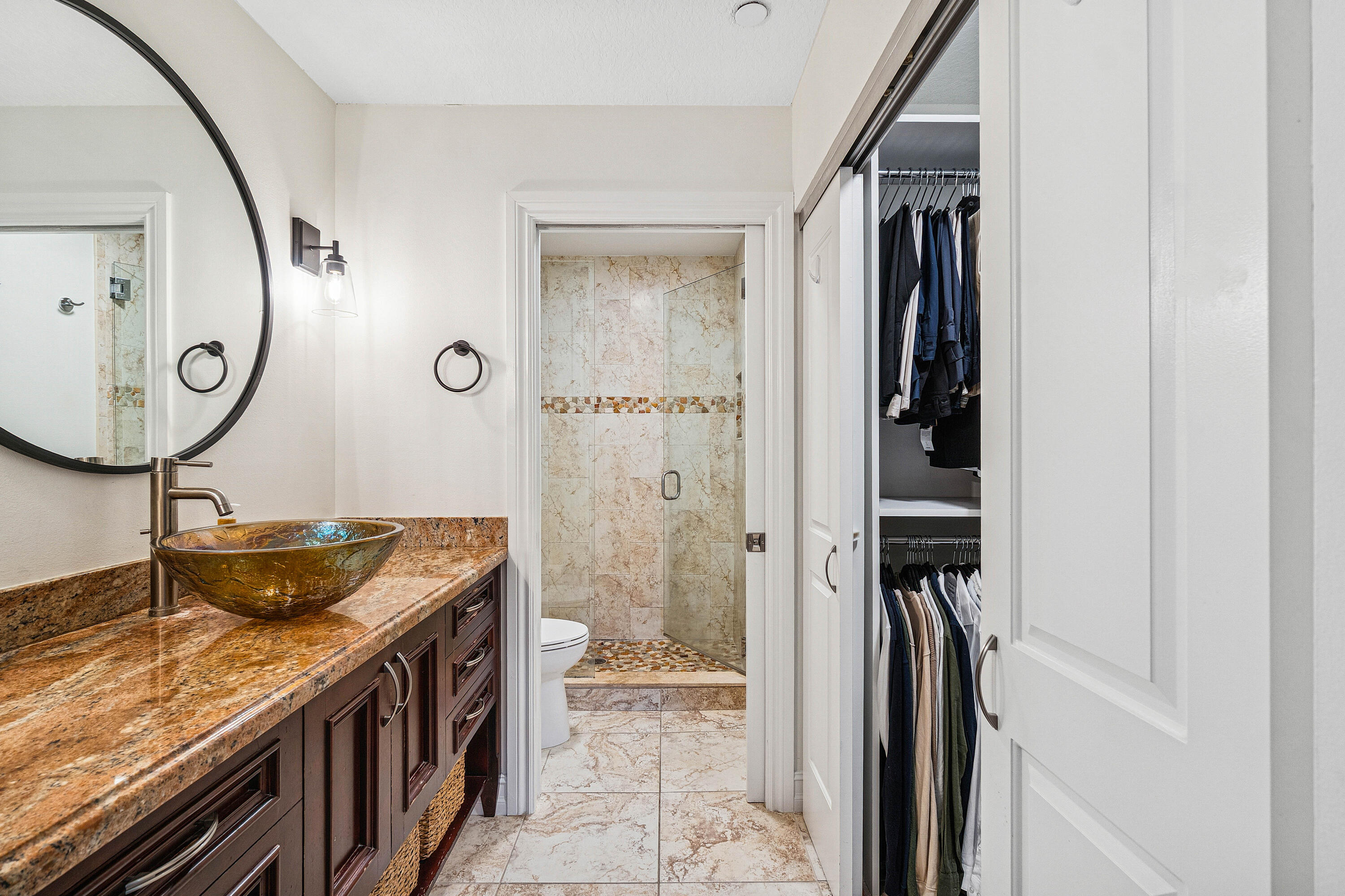 340 Northwest 67th Street, Unit 202 Boca Raton, FL 33487 - Photo 20 of 39 a bathroom with a granite countertop sink a mirror and a shower