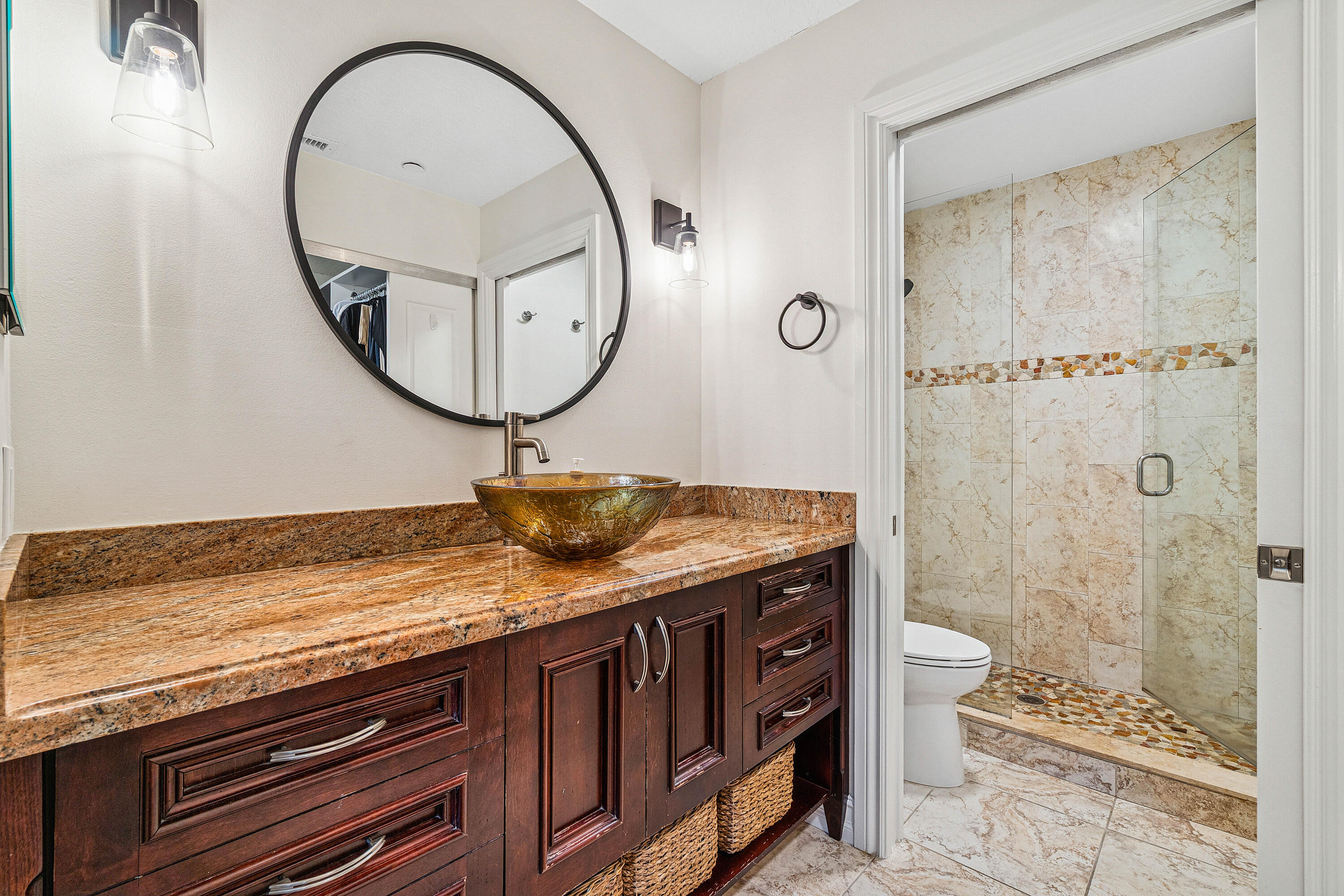 340 Northwest 67th Street, Unit 202 Boca Raton, FL 33487 - Photo 21 of 39 a bathroom with a granite countertop sink a toilet and a mirror