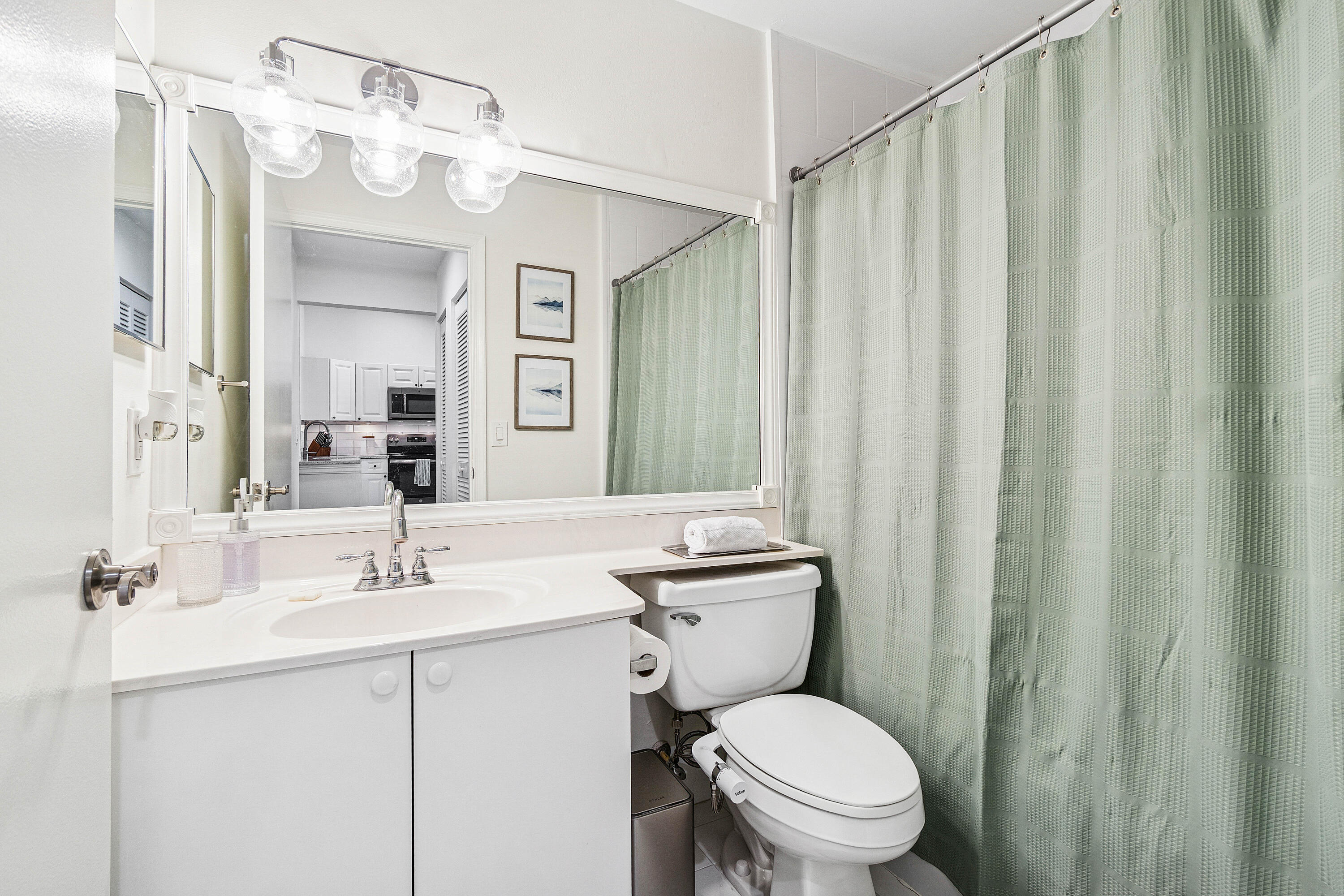 340 Northwest 67th Street, Unit 202 Boca Raton, FL 33487 - Photo 26 of 39 a bathroom with a sink a toilet a mirror and shower curtain