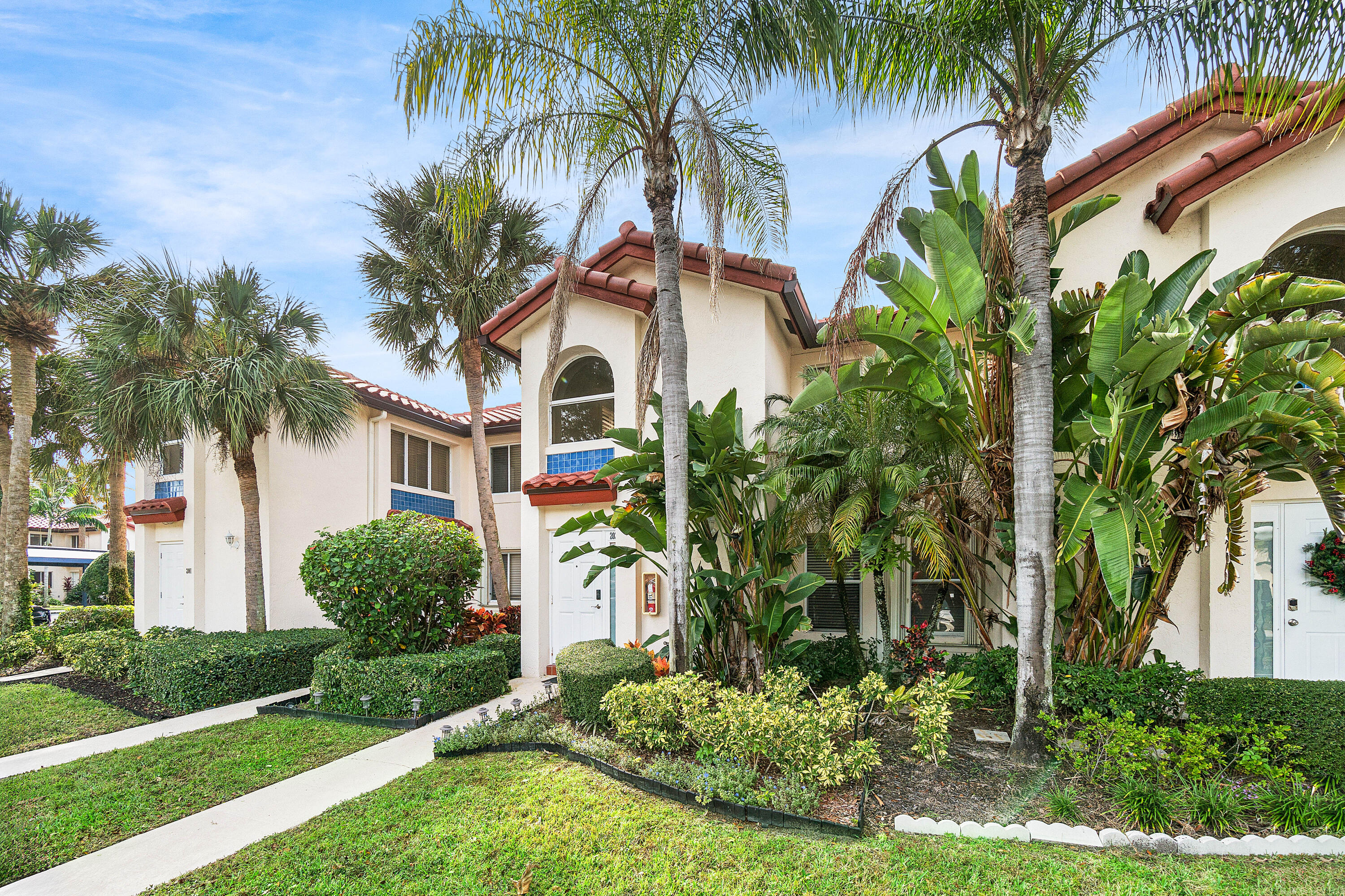 340 Northwest 67th Street, Unit 202 Boca Raton, FL 33487 - Photo 3 of 39 a front view of house with yard and green space