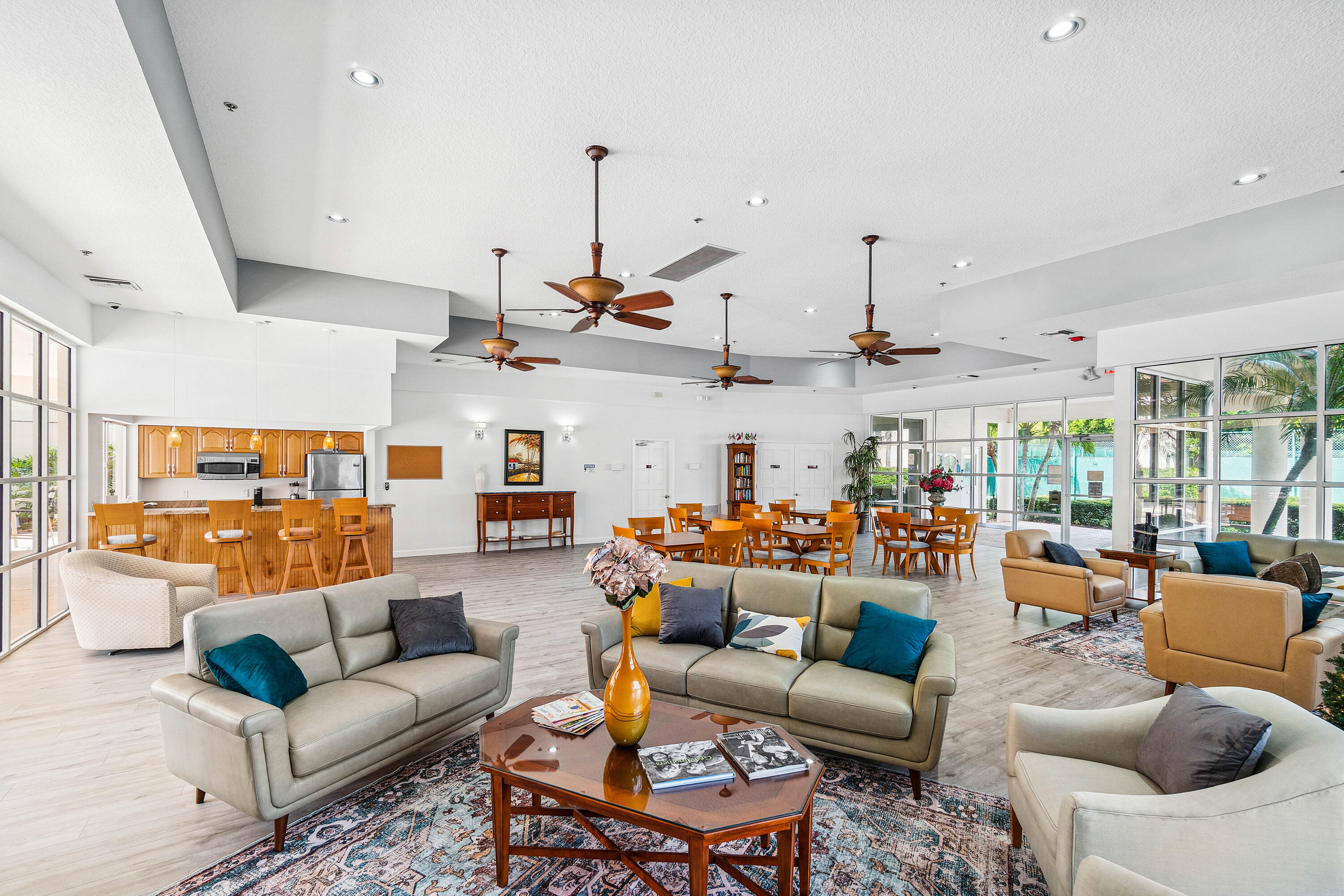 340 Northwest 67th Street, Unit 202 Boca Raton, FL 33487 - Photo 34 of 39 a living room with furniture kitchen view and a chandelier