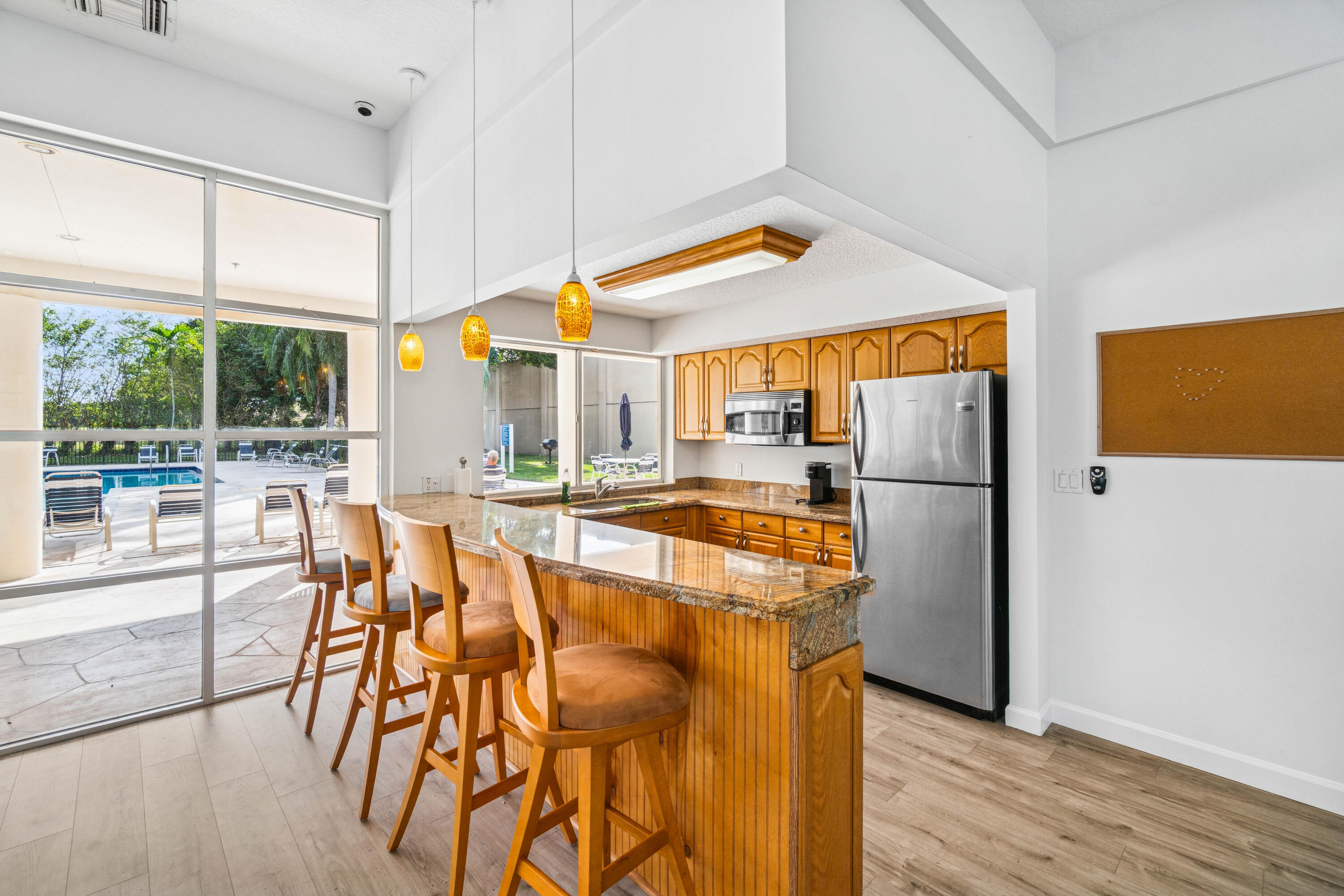 340 Northwest 67th Street, Unit 202 Boca Raton, FL 33487 - Photo 35 of 39 a kitchen with stainless steel appliances granite countertop a refrigerator and a stove top oven