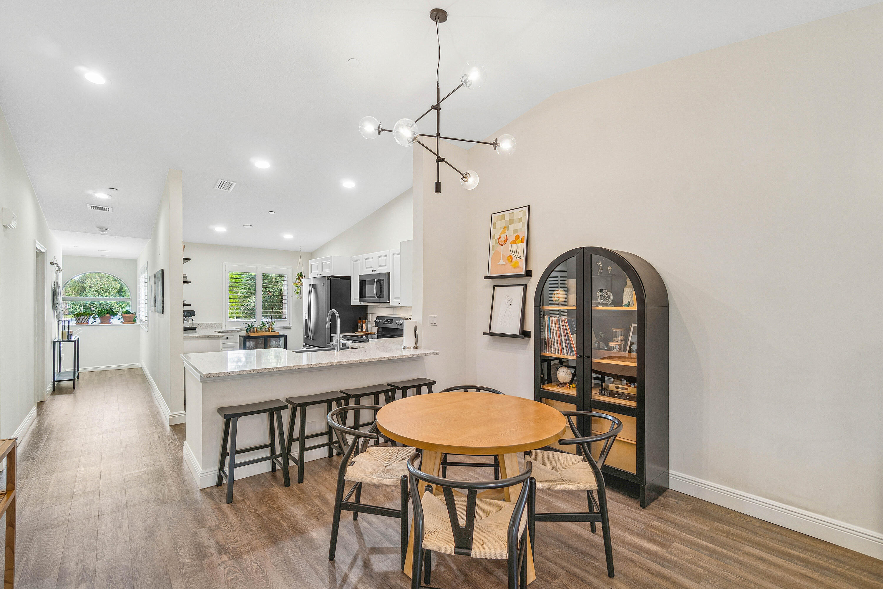 340 Northwest 67th Street, Unit 202 Boca Raton, FL 33487 - Photo 4 of 39 a view of a dining room with furniture window and wooden floor