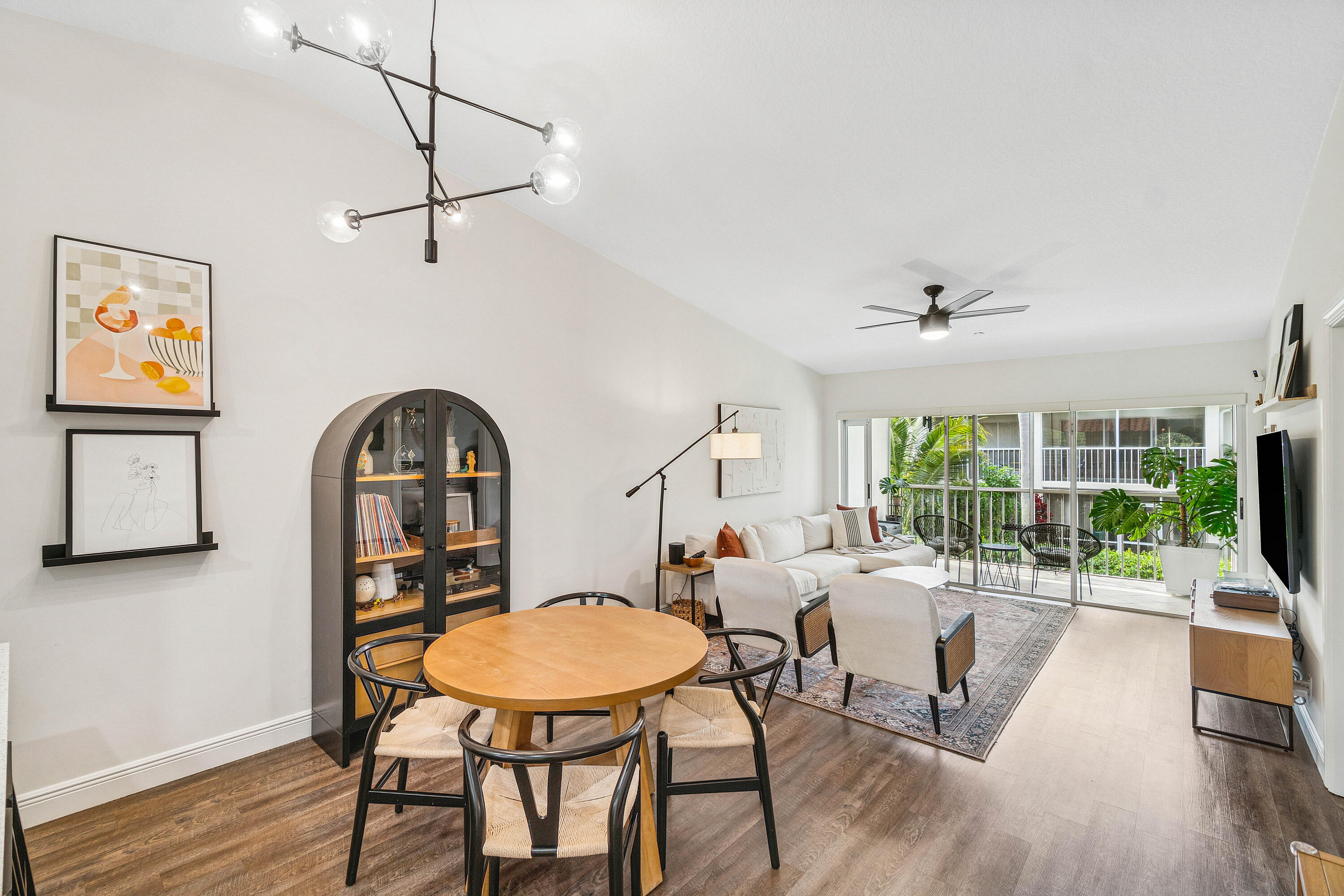 340 Northwest 67th Street, Unit 202 Boca Raton, FL 33487 - Photo 5 of 39 a living room with furniture a flat screen tv and a large window
