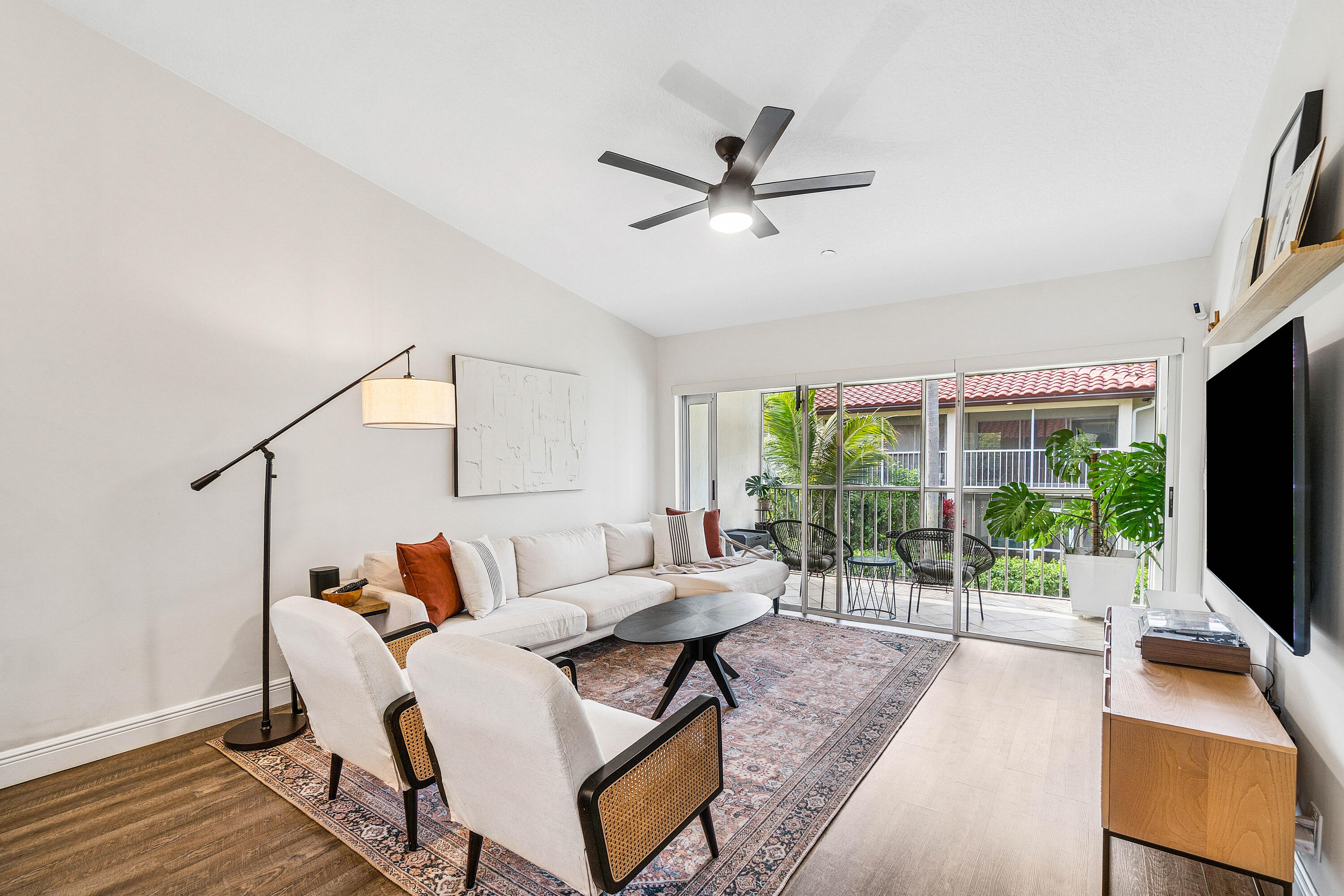 340 Northwest 67th Street, Unit 202 Boca Raton, FL 33487 - Photo 6 of 39 a living room with furniture and a flat screen tv