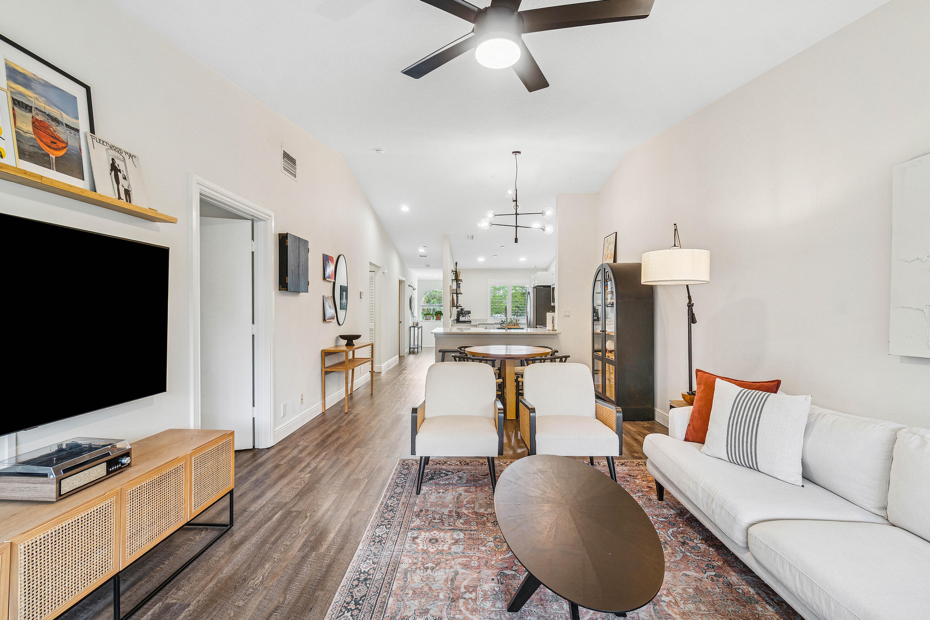 340 Northwest 67th Street, Unit 202 Boca Raton, FL 33487 - Photo 8 of 39 a living room with furniture and a flat screen tv