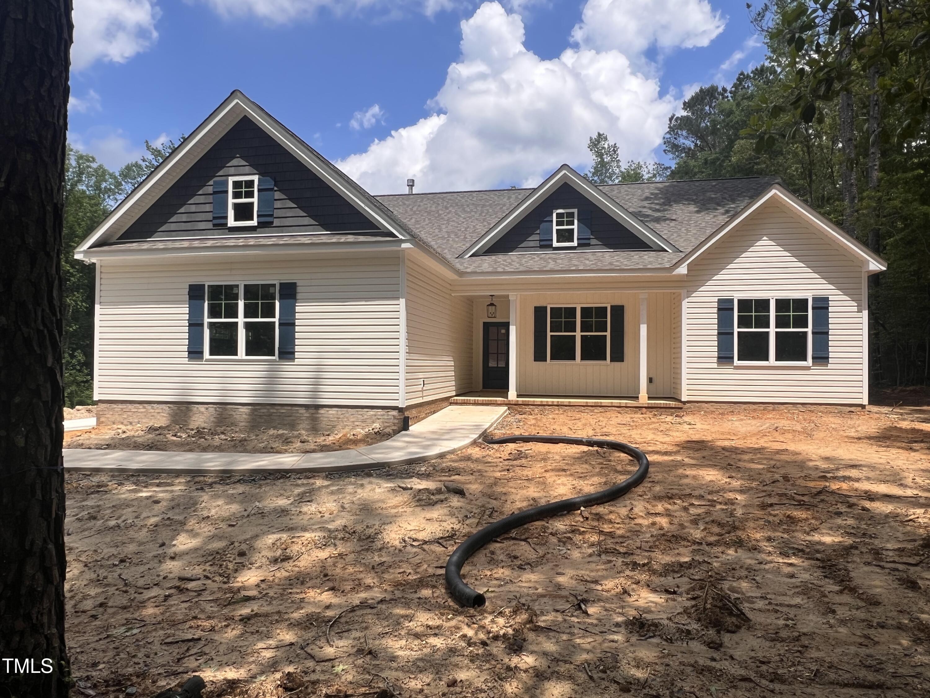 987 Lewis Road Zebulon, NC 27597 - Photo 1 of 13 a house view with a garden space