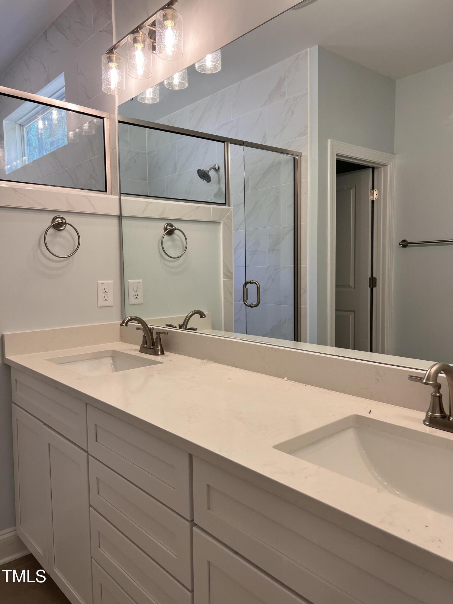 987 Lewis Road Zebulon, NC 27597 - Photo 10 of 13 a bathroom with a sink and a mirror