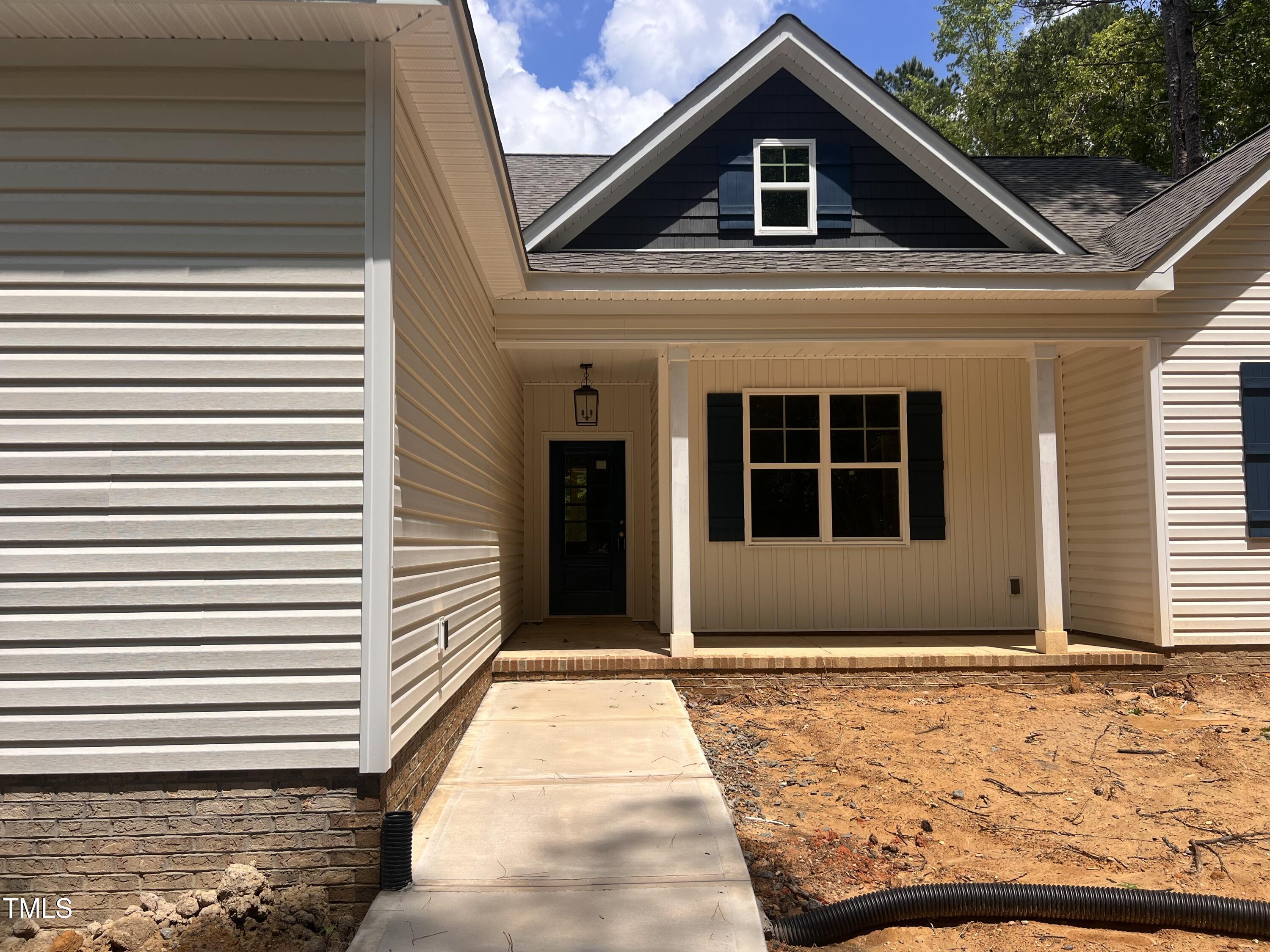 987 Lewis Road Zebulon, NC 27597 - Photo 2 of 13 a front view of a house with a yard