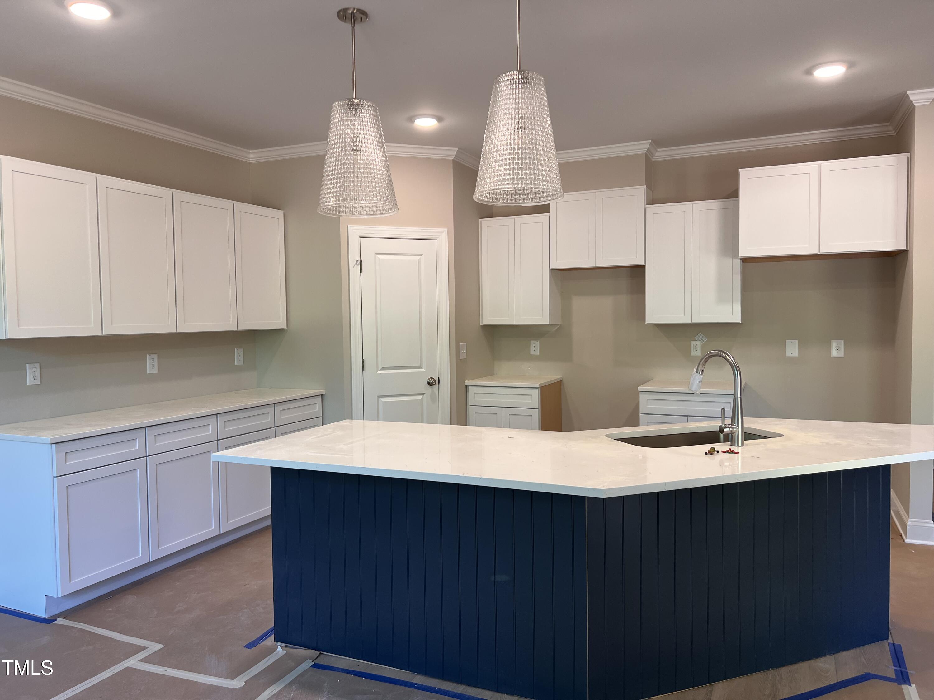 987 Lewis Road Zebulon, NC 27597 - Photo 3 of 13 a kitchen with kitchen island granite countertop a sink cabinets and stainless steel appliances