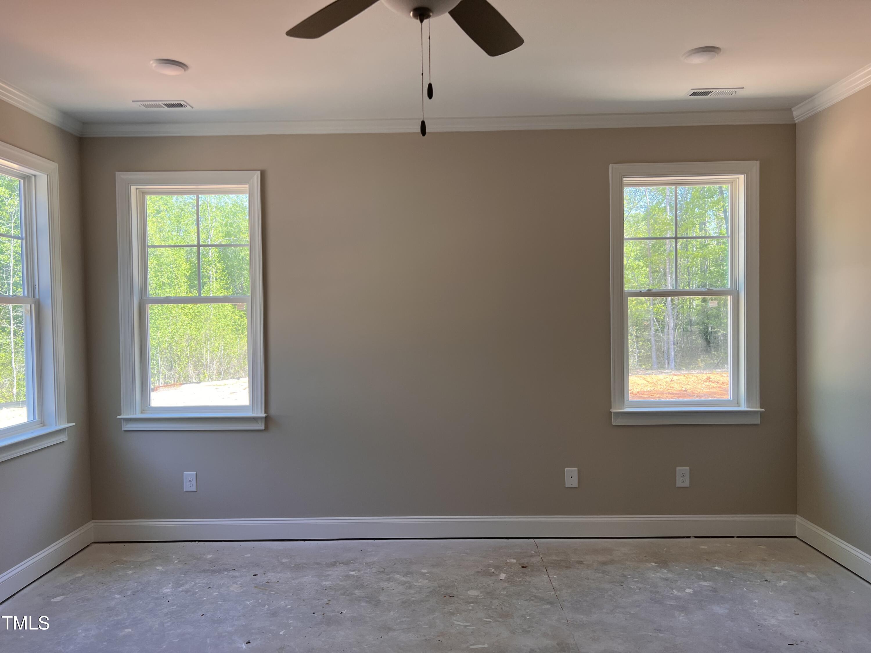 987 Lewis Road Zebulon, NC 27597 - Photo 8 of 13 an empty room with a window
