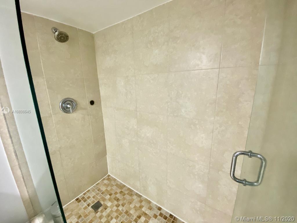 2101 Brickell Avenue, Unit 2002 Miami, FL 33129 - Photo 13 of 26 a bathroom with a shower