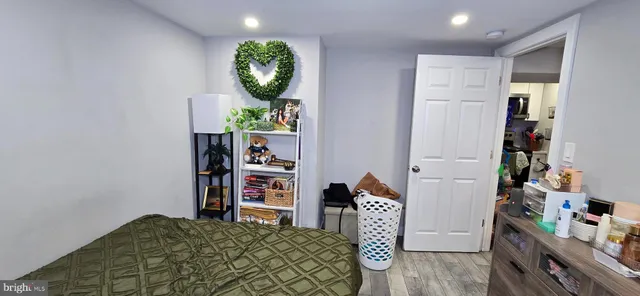 a bedroom with furniture and a wooden floor