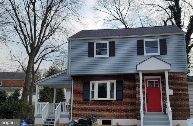 a front view of a house with trees