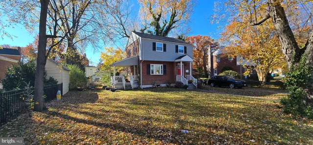 a view of a house with a yard covered in snow