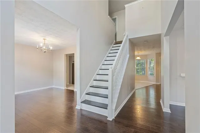 a view of a hallway with wooden floor and entryway