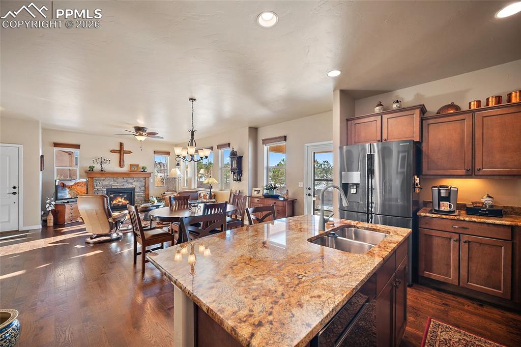 12988 Cupcake Heights Colorado Springs, CO 80921 - Photo 11 of 39 a kitchen with sink refrigerator and cabinets