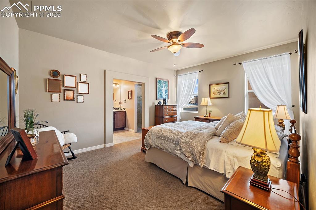 12988 Cupcake Heights Colorado Springs, CO 80921 - Photo 14 of 39 a bedroom with a bed and wooden floor