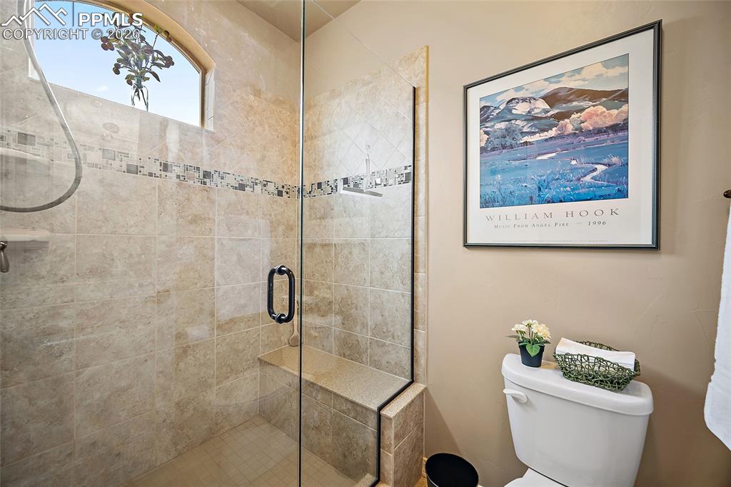 12988 Cupcake Heights Colorado Springs, CO 80921 - Photo 18 of 39 a bathroom with a toilet and a shower