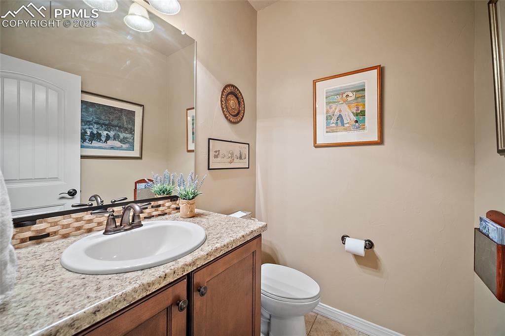 12988 Cupcake Heights Colorado Springs, CO 80921 - Photo 20 of 39 a bathroom with a granite countertop sink and a toilet