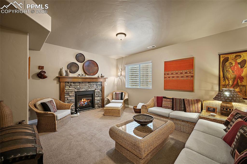 12988 Cupcake Heights Colorado Springs, CO 80921 - Photo 21 of 39 a living room with furniture and a fireplace