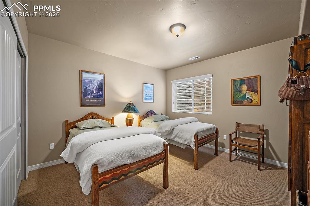 12988 Cupcake Heights Colorado Springs, CO 80921 - Photo 27 of 39 a bedroom with bed and a window