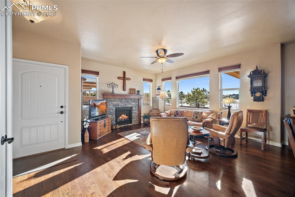 12988 Cupcake Heights Colorado Springs, CO 80921 - Photo 6 of 39 a view of a dining room with furniture window and wooden floor