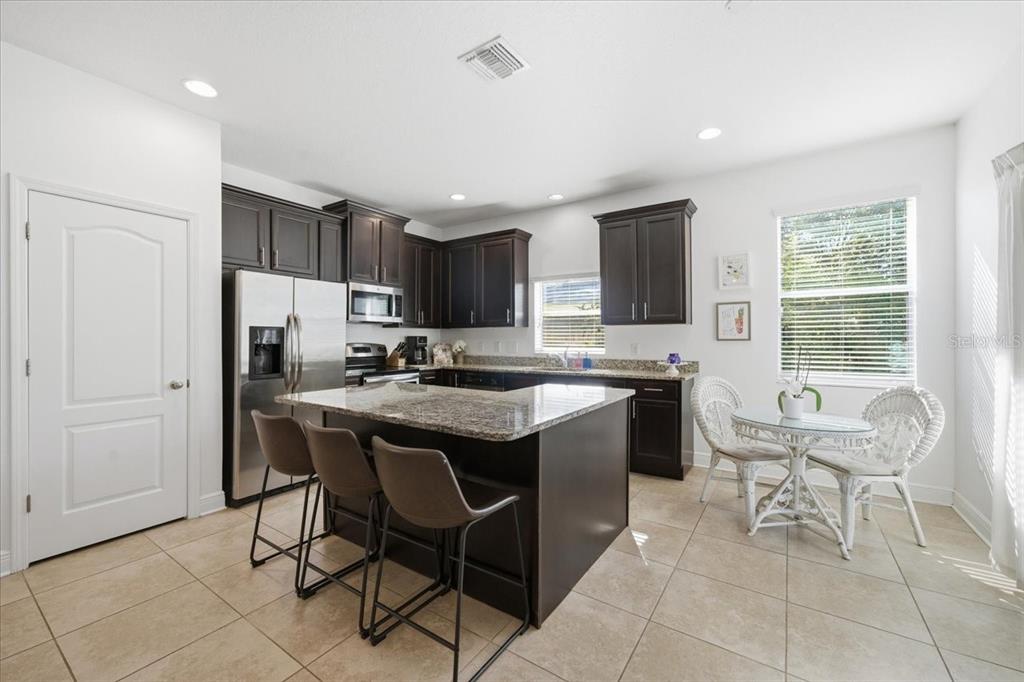 12330 North Rome Avenue Tampa, FL 33612 - Photo 11 of 33 a kitchen with a sink a counter top space appliances and cabinets