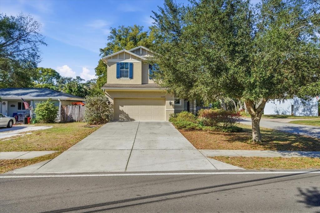 12330 North Rome Avenue Tampa, FL 33612 - Photo 2 of 33 a front view of a house with a yard and garage